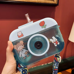 Bonita botella de agua con pajita y cámara