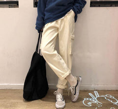 Pantalones negros holgados de cintura alta con bolsillos grandes y elásticos