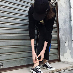 Pantalones deportivos anchos y holgados con cremallera lateral negra