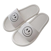 Schwarz-weiß-gelbe Hausschuhe aus Gummi mit Smile-Print