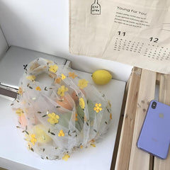 Bonita bolsa de malla transparente con pequeñas flores bordadas