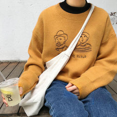 Suéter de punto con cuello redondo, bordado en amarillo, verde y negro