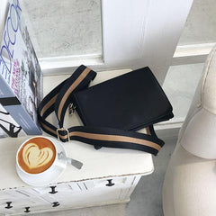 Mini bolso de hombro negro con correa ancha de lona y piel sintética