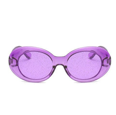 Gafas de sol ovaladas con montura de plástico brillante y lentes transparentes con purpurina