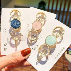 Horquilla con círculos y estrellas de mármol dorado brillante