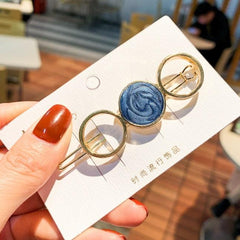 Horquilla con círculos y estrellas de mármol dorado brillante