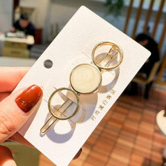 Horquilla con círculos y estrellas de mármol dorado brillante