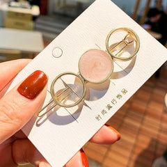 Horquilla con círculos y estrellas de mármol dorado brillante