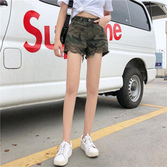 Pantalones cortos vaqueros con bordes rotos y estampado verde militar