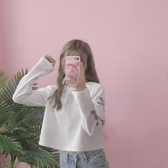 Suéter de punto con cuello redondo y mangas bordadas con flores pequeñas