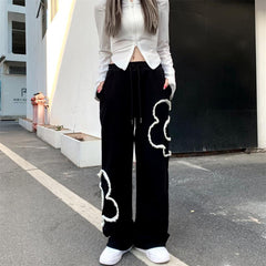 Pantalones deportivos negros holgados con estampado de flores grunge suaves