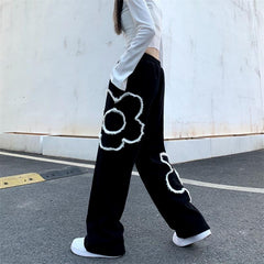 Pantalones deportivos negros holgados con estampado de flores grunge suaves