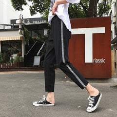 Pantalones deportivos de moda con líneas brillantes en los laterales, de gran tamaño