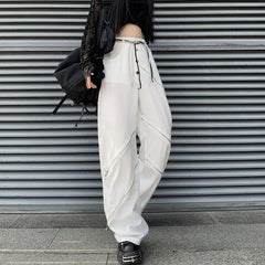 Pantalones blancos de cintura alta y pierna ancha con cortes en las rodillas