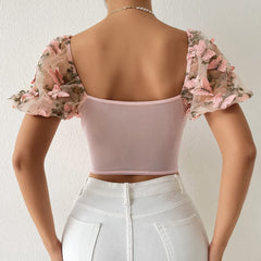 Top corto de malla con mangas abullonadas y bordado floral rosa