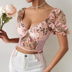 Top corto de malla con mangas abullonadas y bordado floral rosa