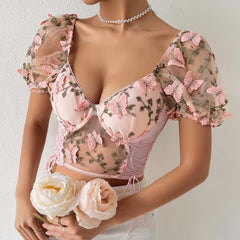 Top corto de malla con mangas abullonadas y bordado floral rosa