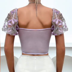 Top corto de malla con mangas abullonadas y bordado floral morado